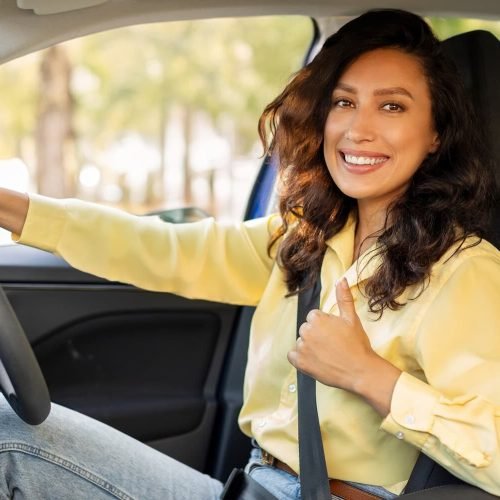 happy-european-woman-showing-thumb-up-smiling-sitting-inside-new-modern-car-first-road-trip-1-e1743712420922.jpg